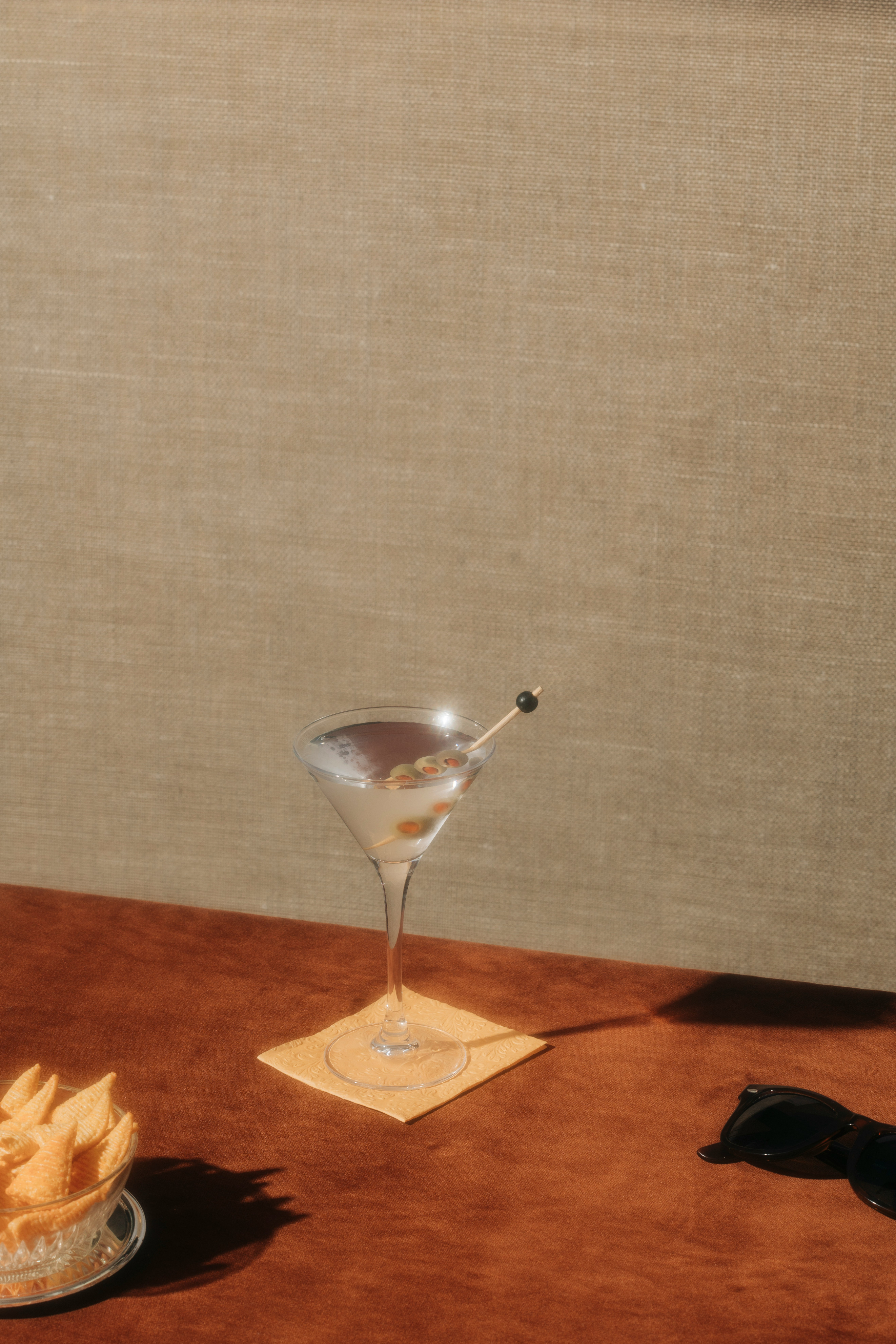 Elegant cocktail glass on a textured brown tablecloth